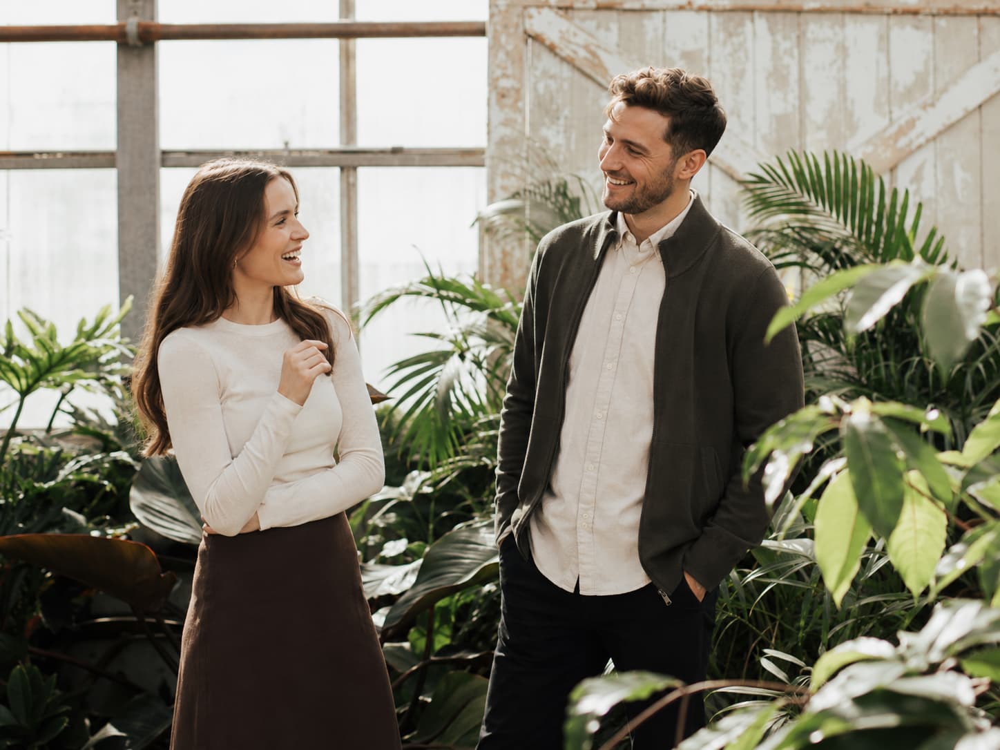 Two colleagues talking in a plant-filled office